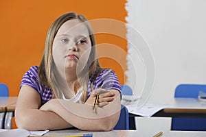 Portrait of girl (10-12) with Down syndrome in classroom