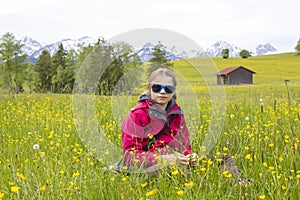 Portrait of a girl against the panorama of the Alps