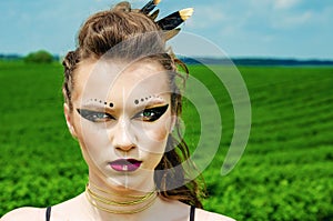 Portrait of a girl with aggressive makeup amazon, viking, shaman
