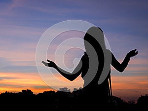 Portrait of girl as silhouette with twilight background