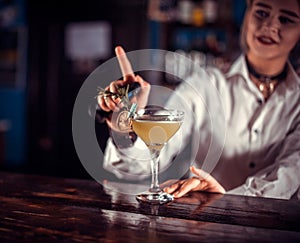 Portrait of girl bartending is pouring a drink in the pub