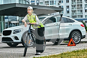 Portrait of a girl on bicycle in an emergency vest