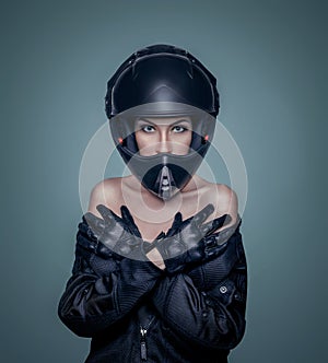 Portrait of a girl in a black motorcycle helmet and jacket
