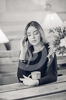 Portrait of a girl. Brunette in a coffee shop. elegant lady in a black dress, in a restaurant alone. Girl in a cafe