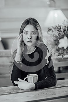 Portrait of a girl. Brunette in a coffee shop. elegant lady in a black dress, in a restaurant alone. Girl in a cafe