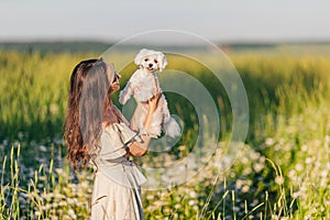 Portrait of girl on a chamomile field in summer