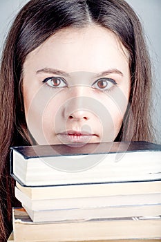 Portrait of the girl close up with books