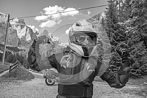 Portrait of girl dressed in protective suit of body armor, tutle prtotective jacket, with helmet and glowes. Adventure motorcycle