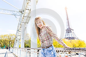 Portrait of a girl with Eiffel Tower on background in Paris
