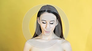 Portrait of the girl with emotion of crying on yellow background in 4K