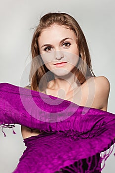 Portrait of girl enveloped into violet scarf