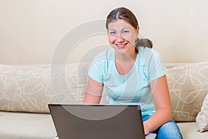 Portrait of a girl of European appearance with a laptop