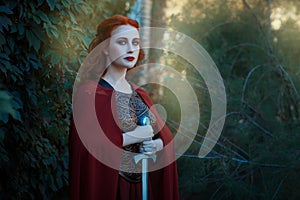 Portrait of a girl female warrior with sword in hand.