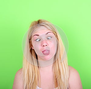 Portrait of girl with funny face against green background