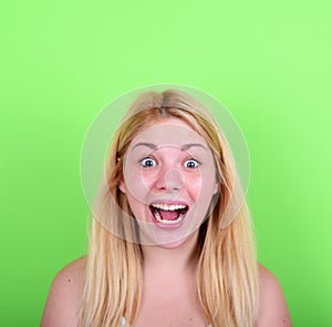 Portrait of girl with funny face against green background