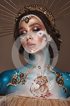 Portrait of a girl with gold and blue creative art make-up. photo