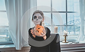 Portrait of girl with haloween pumpkin