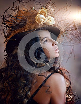 Portrait of girl in hat with dry flowers