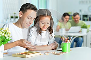 Portrait of girl and her her brother studying together