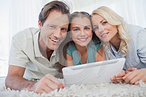 Portrait of a girl and her parents using a tablet