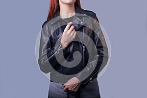 Portrait of a girl in a high-quality leather jacket. Rock and roll style in women. Promotional photo of a leather jacket