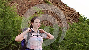 Portrait of girl hiker with backpack on mountain.