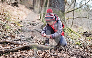 Portrait of girl on hiking forest trip tying shoe laces