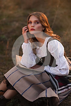 Portrait of a girl in a historical dress with a book