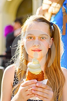 Portrait of a girl holding ice cream in a sunny summer day