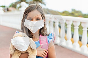 Portrait of a girl with hygienic face mask to prevent infection, illness, flu or 2019-nCoV. Concept back to school in the stage of