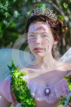 Portrait of a girl in image of a fairy with a tiara on her head