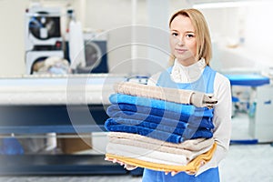 Portrait of a girl Laundry worker holding a clean towel