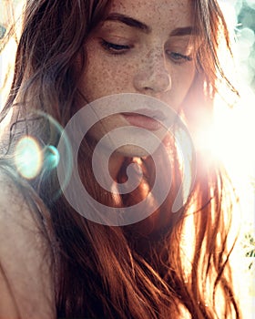 Portrait of a girl with red hair in the Sun photo