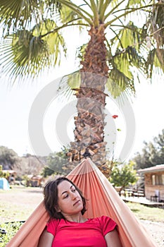 Portrait of a girl lying in a hammock