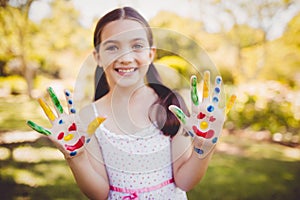 Portrait of a girl with make-up showing her painted hands