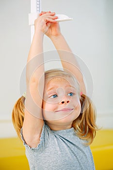 Portrait of girl measuring herself