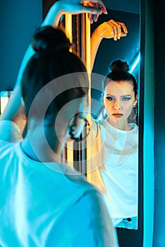 Portrait of a girl with neon lighting. Beautiful girl in a Studio with colored light