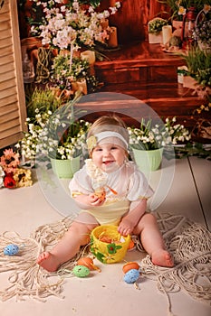 Portrait girl one year old shooting in the studio in the background flowers wooden background dekor