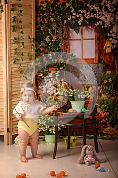 Portrait girl one year old shooting in the studio in the background flowers wooden background dekor photo