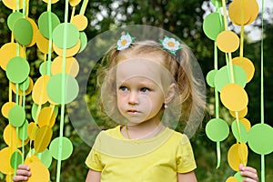 Portrait of girl in paper circle colorful curtain garland