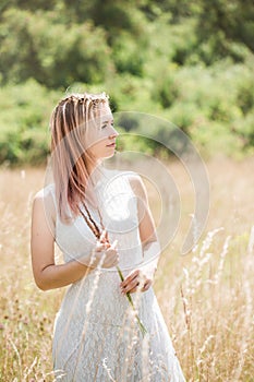 Portrait of a girl with pink hair decorated with little daisies