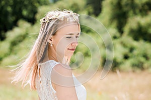 Portrait of a girl with pink hair decorated with little daisies, close-up