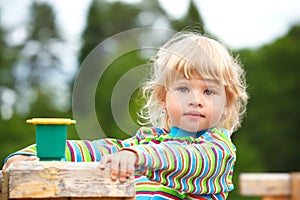 Portrait of the girl on a playground with a toy