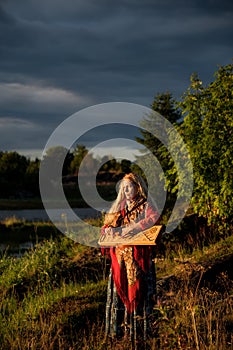 Portrait of a girl playing the gusli in Rabocheostrovsk, Republic Kareliya