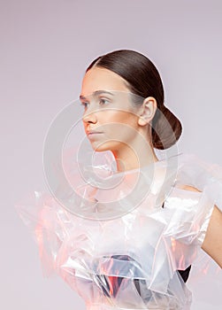 Portrait of a girl in polyethylene. Fashion portrait.