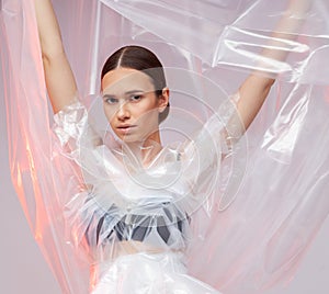 Portrait of a girl in polyethylene. Fashion portrait