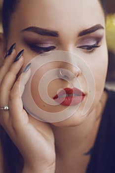 Portrait of a girl with professional make-up,.smoky eyes, red lips and smooth eyebrows. Limbed eyebrows.