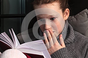 Portrait of girl reading book