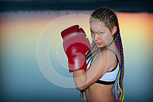 Portrait of a girl with red boxing gloves