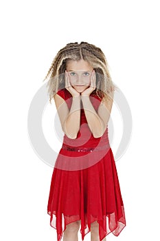 Portrait of girl in red frock with head in hands over white background